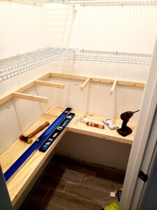 Custom pantry makeover with wood shelf installation